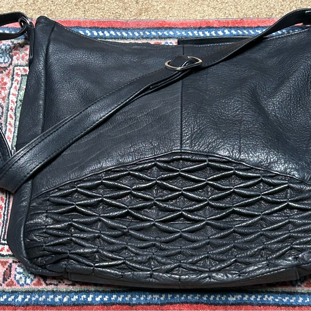 Women’s leather hobo bag in black.  Leather is soft and pebbled texture